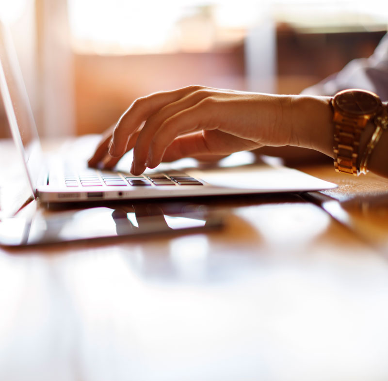 Journalist typing on a laptop