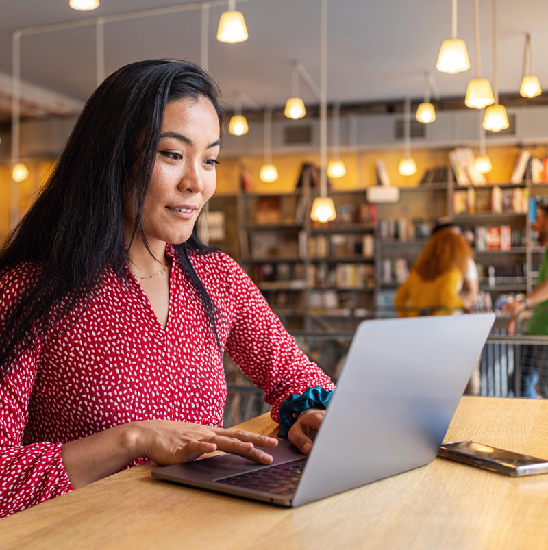 Confident female author working on laptop